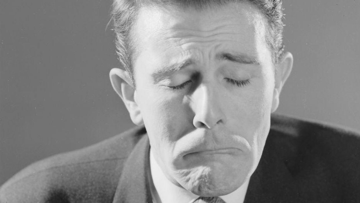 File: A man pulls a face like a little boy trying not to cry, 1960