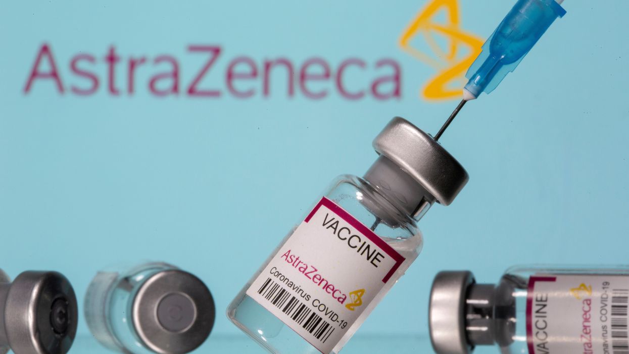 FILE PHOTO: Vials labelled "Astra Zeneca COVID-19 Coronavirus Vaccine" and a syringe are seen in front of a displayed AstraZeneca logo in this illustration photo