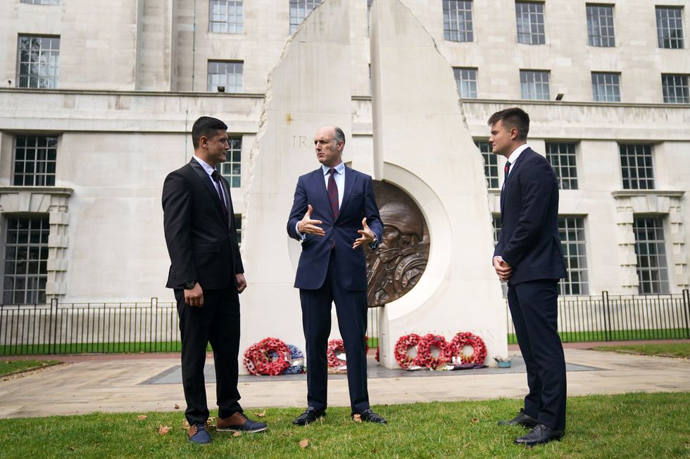 First Lieutenant Mohammad Jawad Akbari, veterans minister Leo Docherty and Captain Dave Kellett by the Iraq Afghanistan Memorial (Victoria Jones/PA)