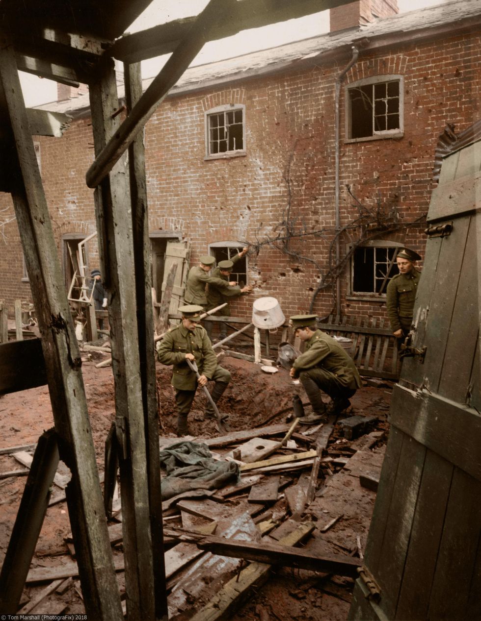 First World War soldiers were often required to help with the clean up operation at home, as well as completing their duties on the Front Line. In this image, soldiers are seen digging with shovels around a bomb crater, and clearing through rubble, in order to make sure a bomb site is safe for residents.
