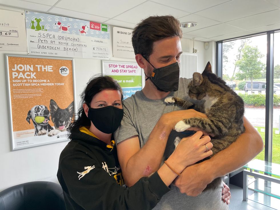 Forbes in the arms of his owners after they went to collect him in Aberdeen (SSPCA)