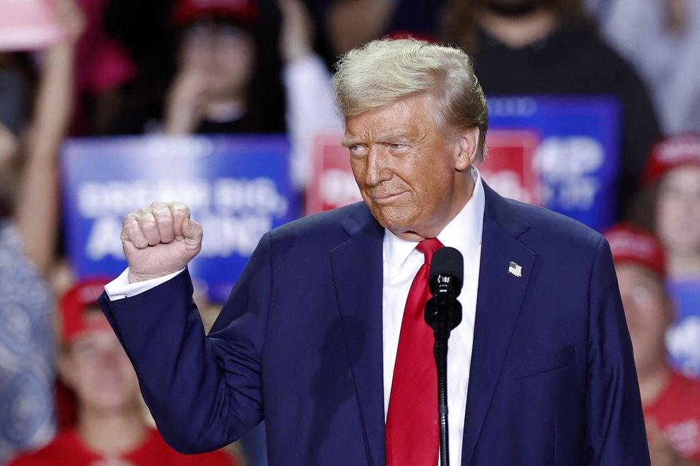 Former US President and Republican presidential candidate Donald Trump gestures as he speaks during a campaign rally at Van Andel Arena in Grand Rapids, Michigan on November 5, 2024