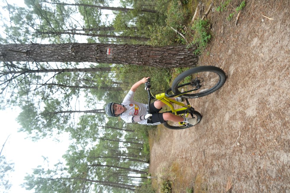 Freddie Tarr on a mountain bike while using a Koalaa tool to hold the handlebars