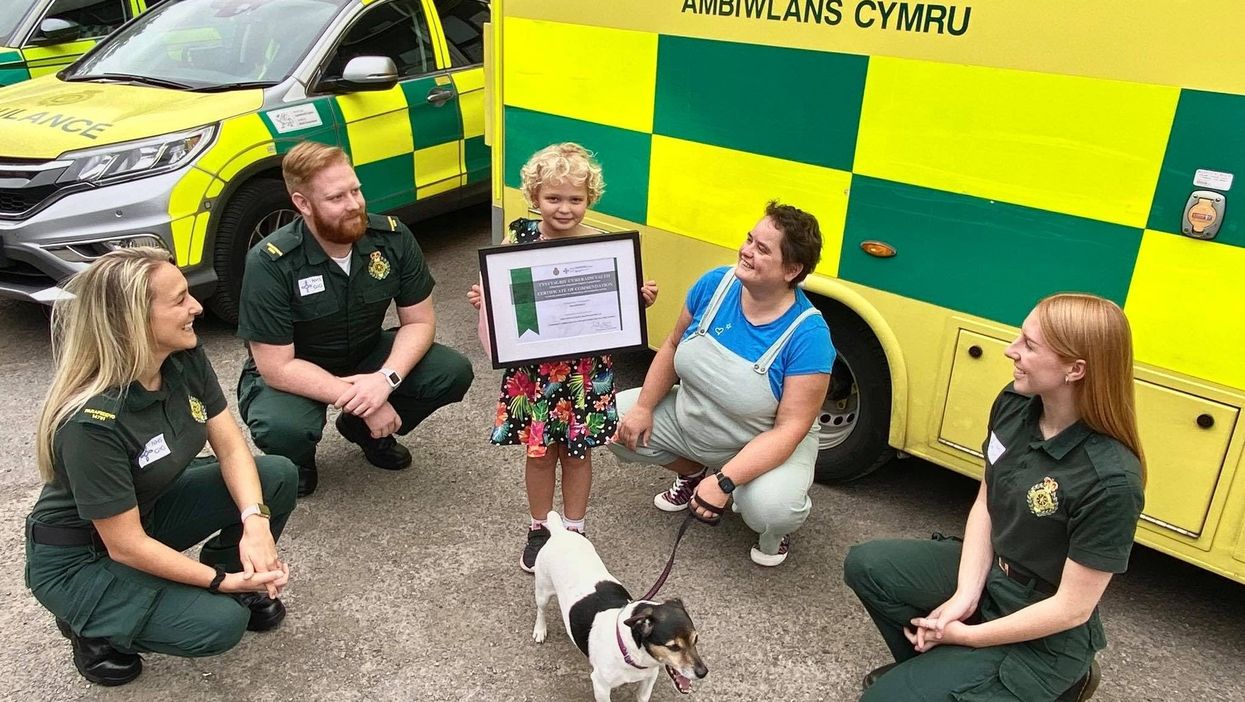 (from left) Paramedics Harriett Thomas and Will Jones, Isla, her mother Katherine Holifield, dog Roly and call handler Madison Vickery (Welsh Ambulances Services NHS Trust/PA)