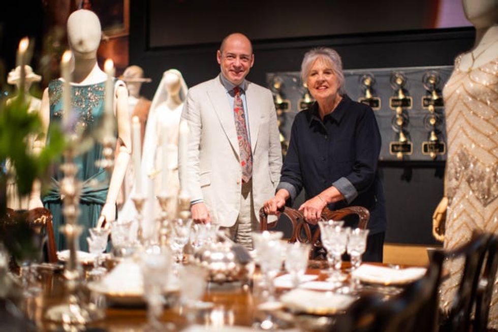 Gareth Neame, chief executive of Carnival Films, standing with actress Penelope Wilton, among a display of props