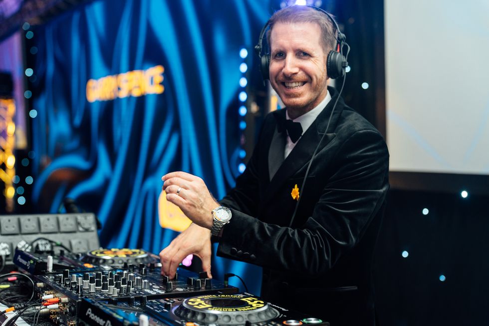 Garry Spence smiling while at a DJ desk