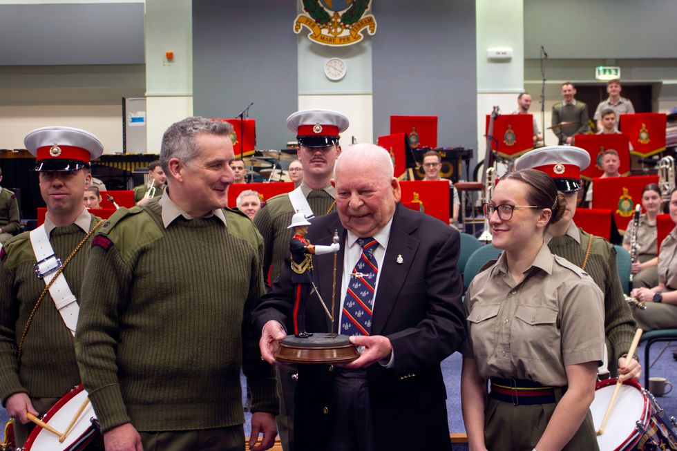 George Latham presents his drum major statue (Ministry of Defence/Crown Copyright/PA)