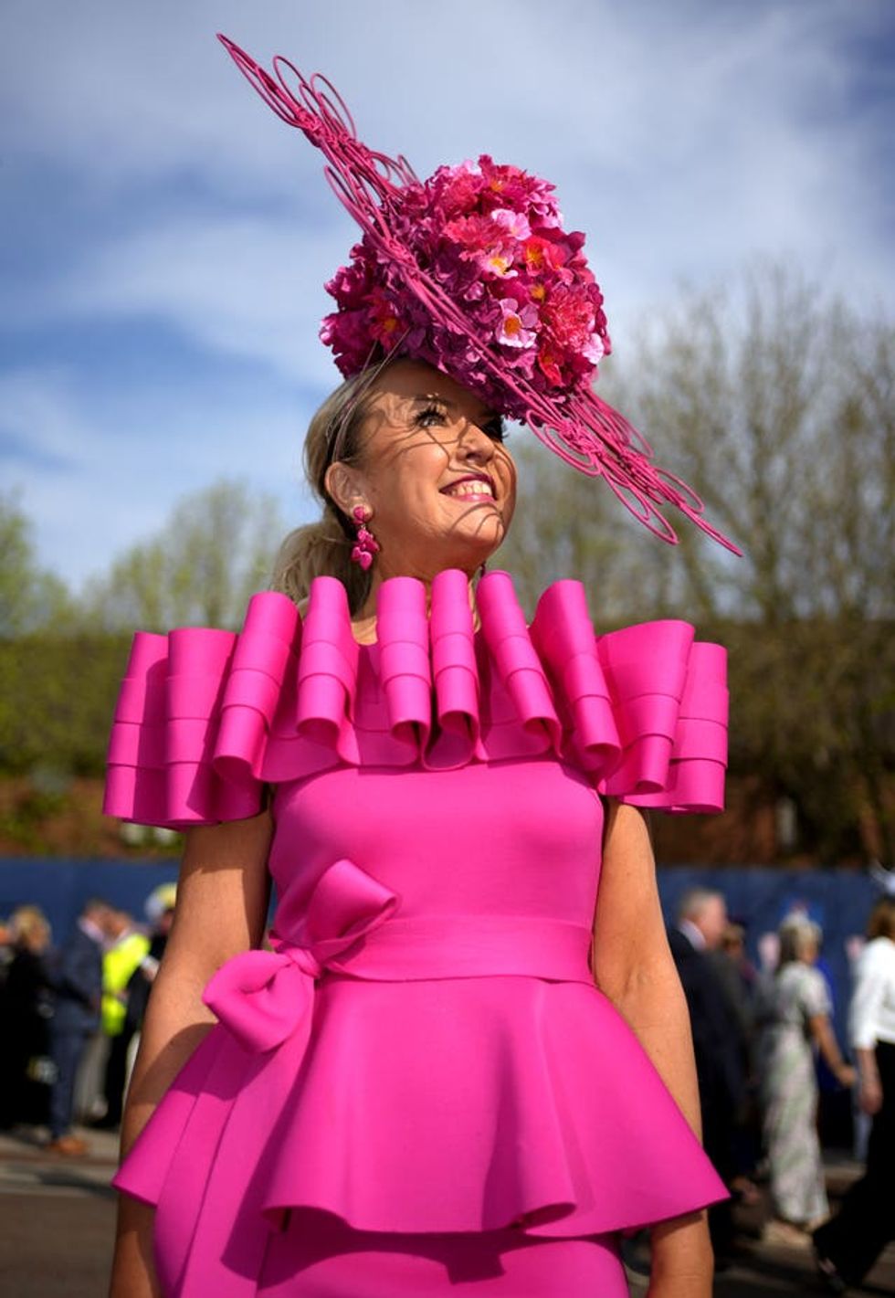 Gill Carpenter in an extravagant pink dress and fascinator