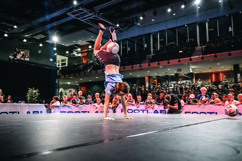 Girl with ball between her feet