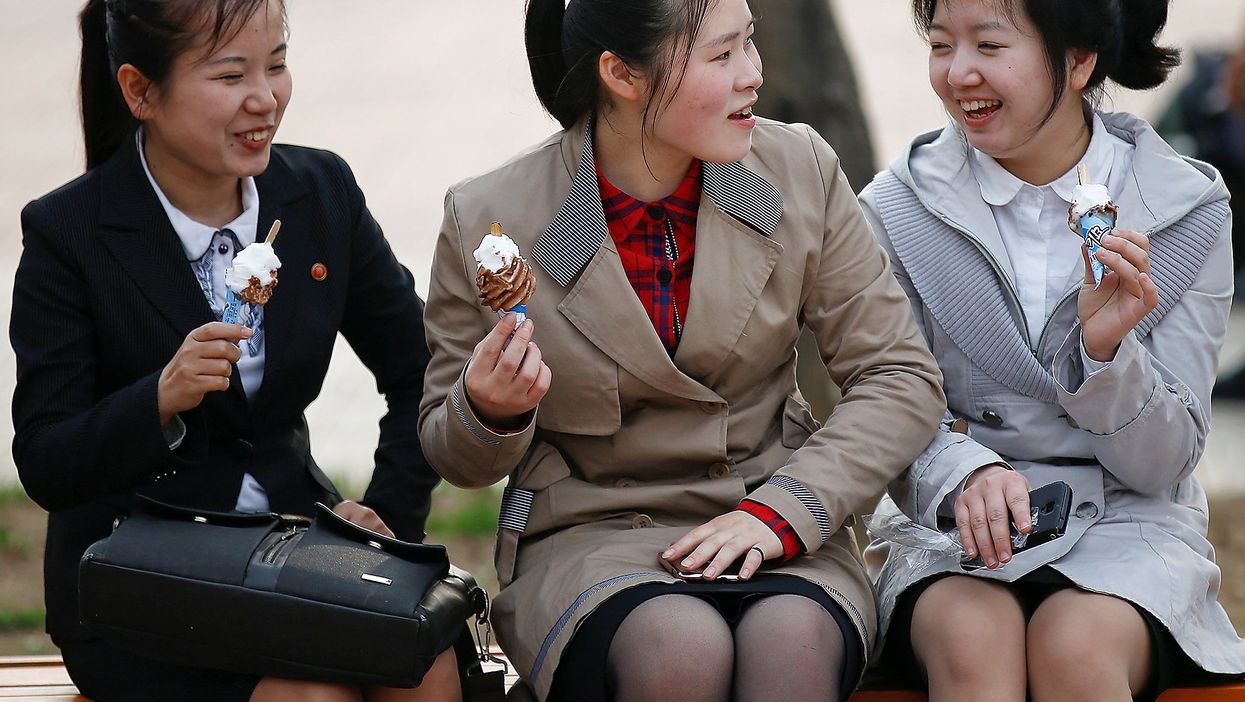Girls enjoy ice cream in a zoo in Pyongyang, North Korea