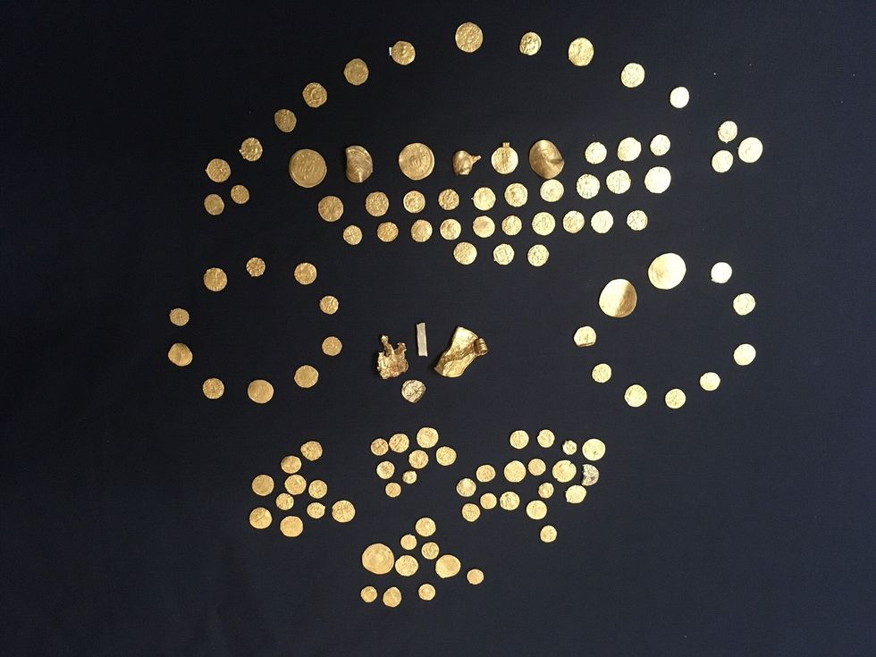 Gold coins, along with four other gold objects, unearthed by metal detectorists (British Museum/PA)