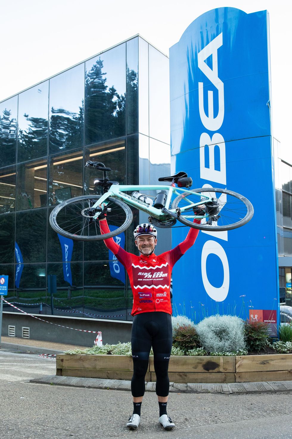 Gordon Miller celebrates at Orbea\u2019s headquarters after completing his attempt to break the world record for the greatest distance covered by an electric bicycle in seven days (James Aubry/PA)
