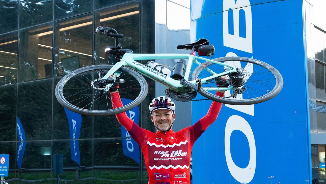 Gordon Miller celebrates at Orbea’s headquarters after completing his attempt to break the world record for the greatest distance covered by an electric bicycle in seven days (James Aubry/PA)