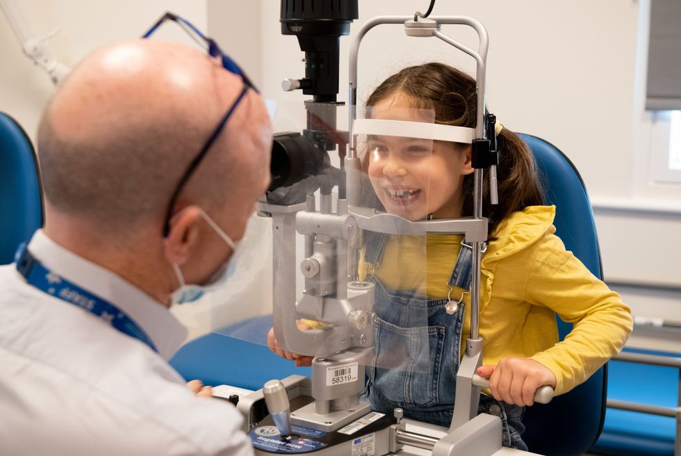 GOSH Consultant Mr Rob Henderson examines patient Beth in the new Sight and Sound Centre supported by Premier Inn_2