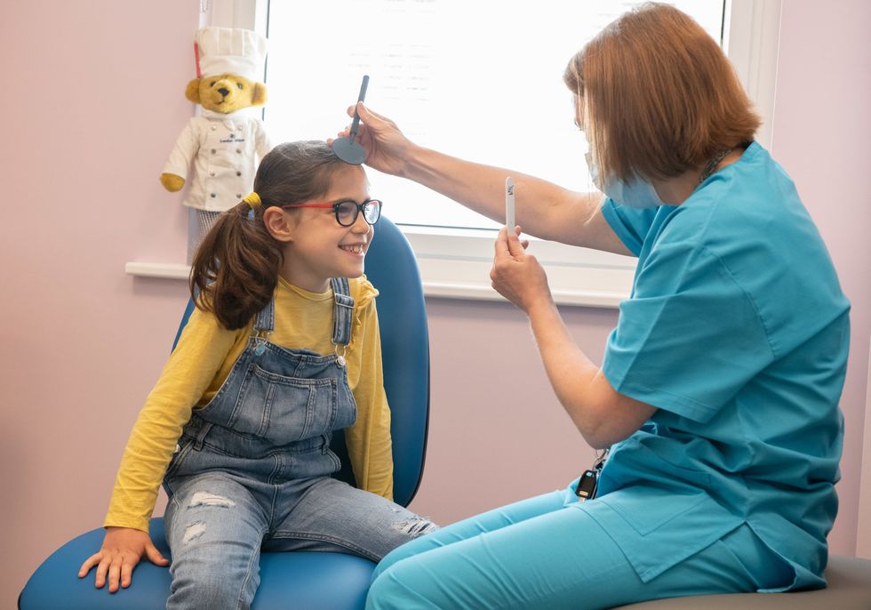 GOSH patient Beth with Bronwen Walters, Head Orthoptist in the Sight and Sound Centre supported by Premier Inn