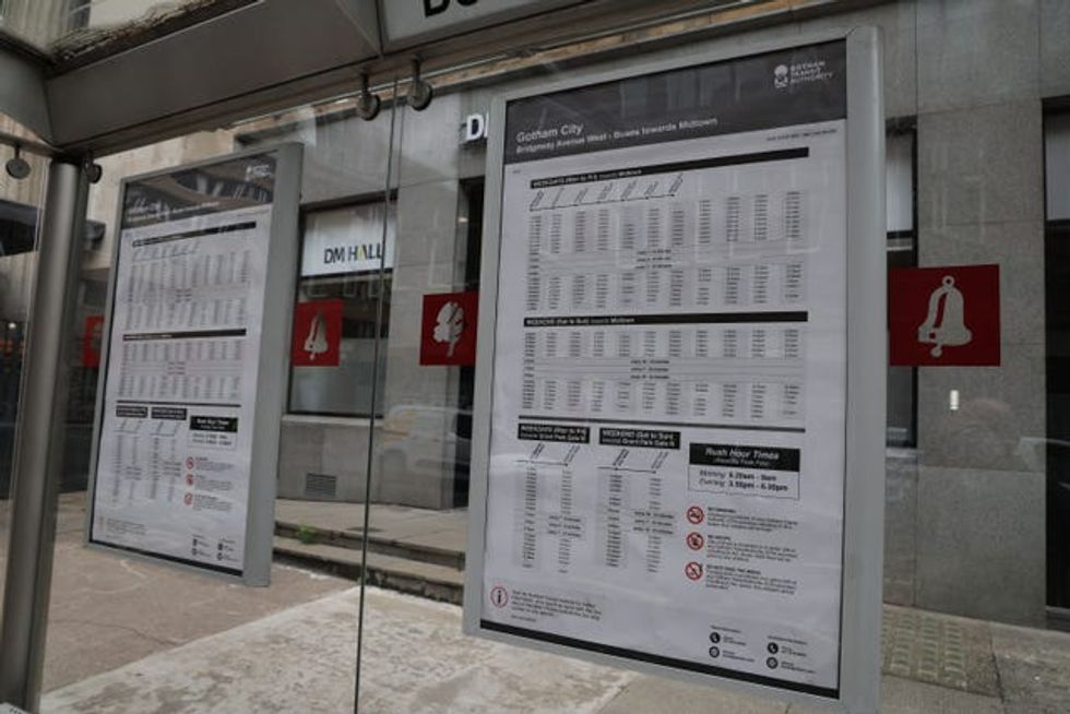 Gotham City bus timetables in a bus stop