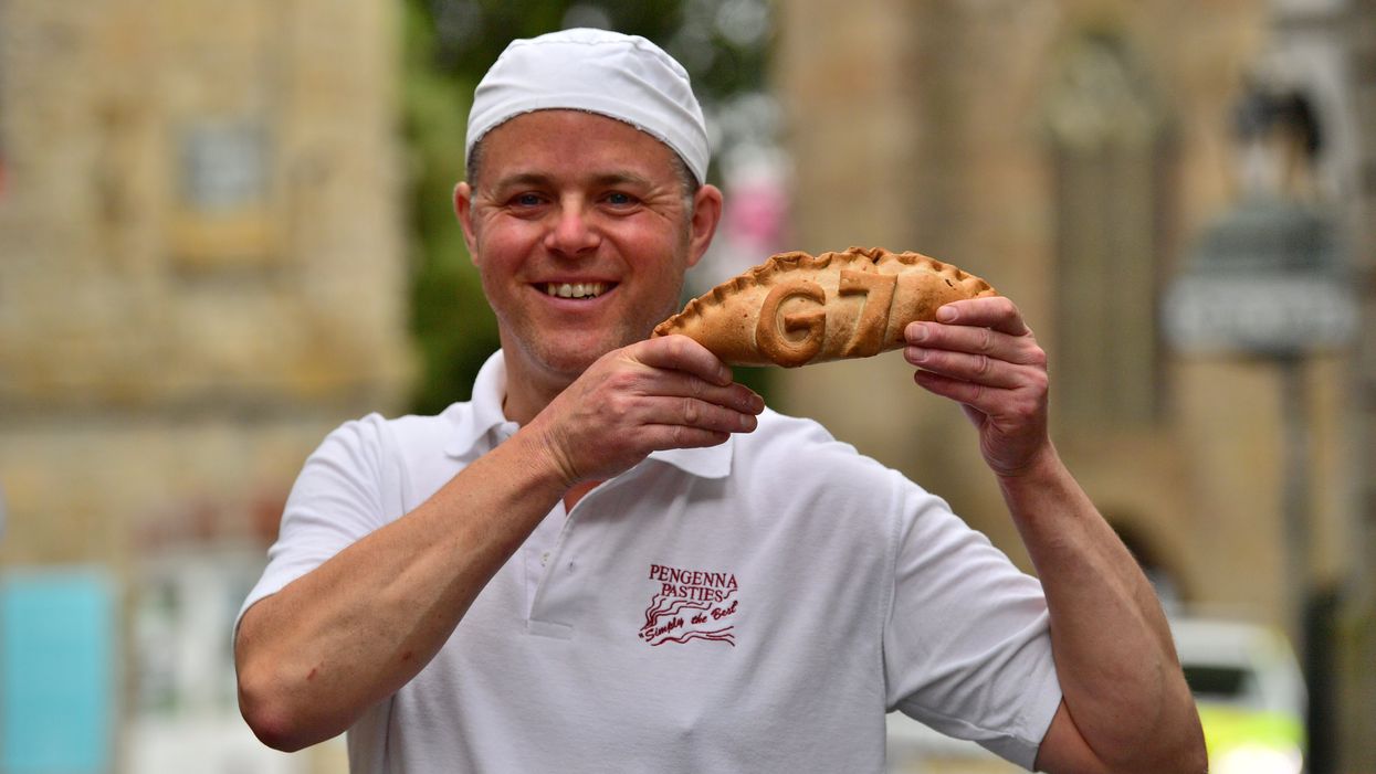Graeme Parkhill, manager of Pengenna Pasties, holding a commemorative G7 pasty in St Ives during the G7 summit in Cornwall