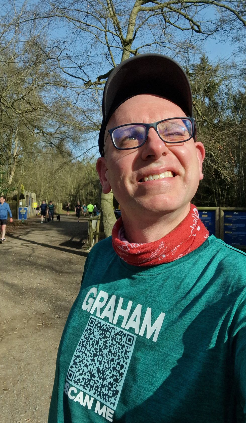 Graham Cooksey wearing a cap, glasses and a T-shirt with his name on