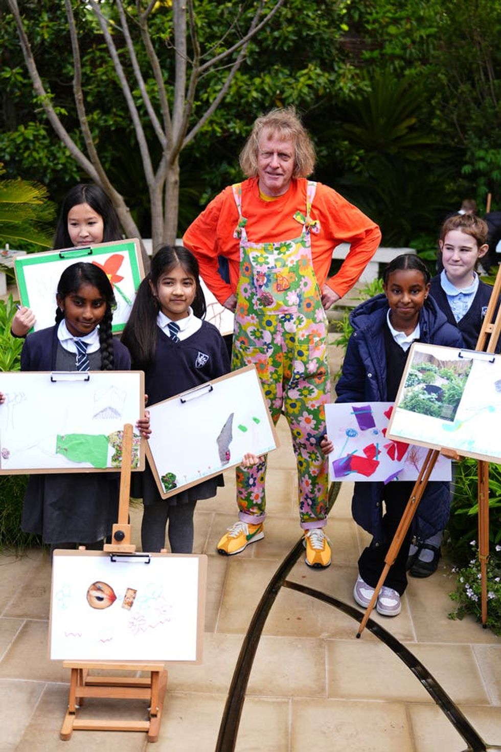 Grayson Perry with children from a local primary school in an art activity at the Tate Britain Garden during press day at the RHS Chelsea Flower Show, at the Royal Hospital Chelsea in London