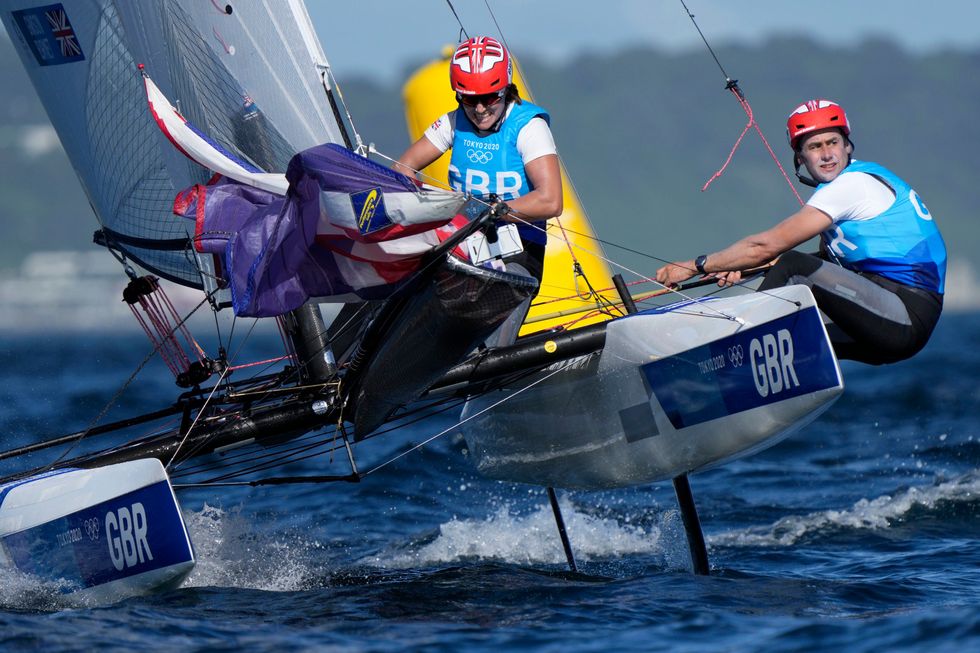 Great Britain\u2019s Anna Burnet and John Gimson compete during the mixed Nacra 17 medal race at the 2020 (AP Photo/Bernat Armangue)