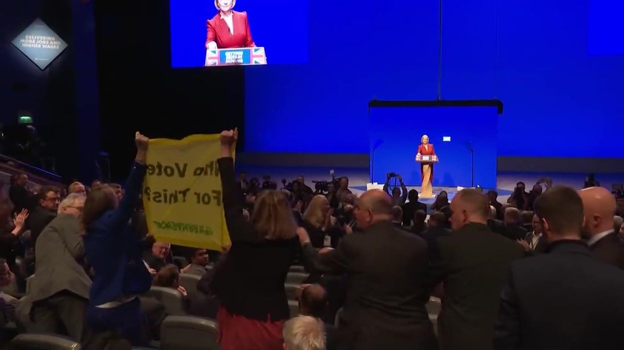 Liz Truss's conference speech interrupted by Greenpeace protesters holding 'who voted for this' sign