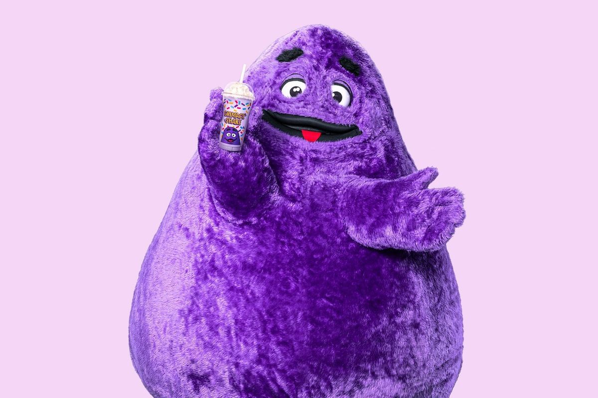 Grimace holding his famous milkshake on a purple background