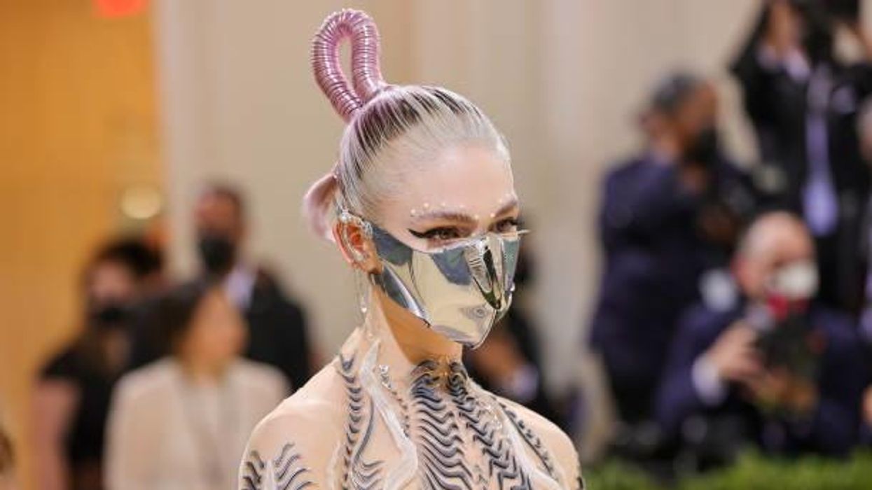Grimes and Elon Musk's 9-month-old pictured 'dancing to techno with a copy of Nietzsche'