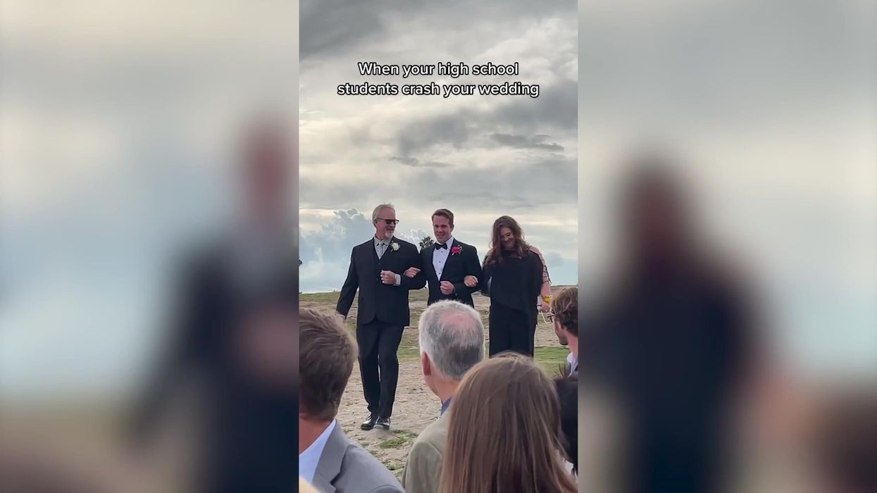 Group of high school students surprise their teacher - by crashing his wedding