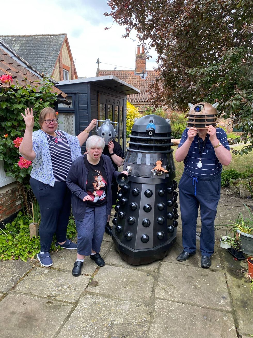 Group posing with Dalek