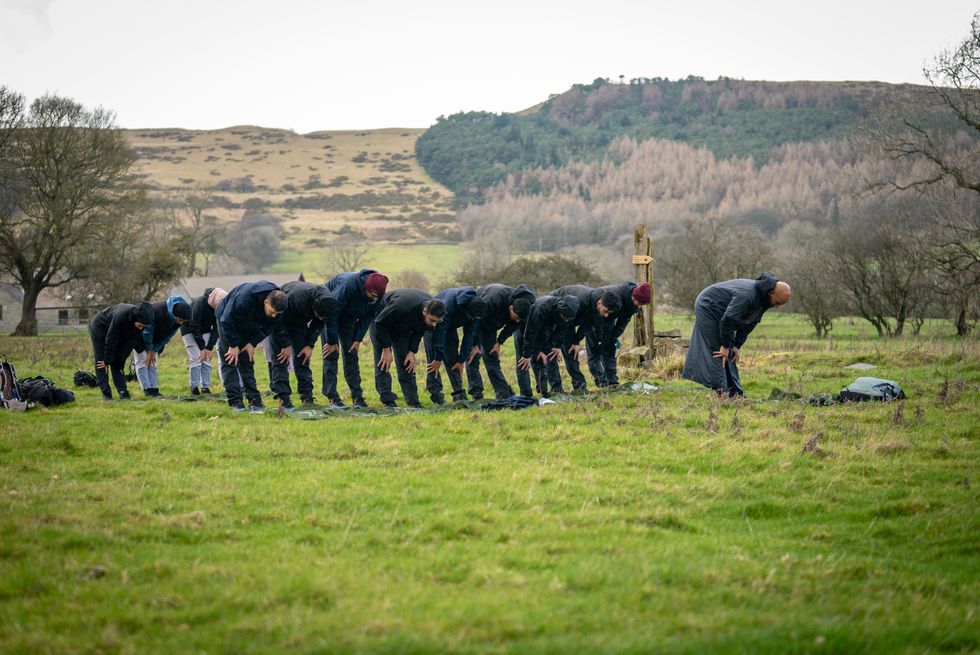 Group standing together and bowing down