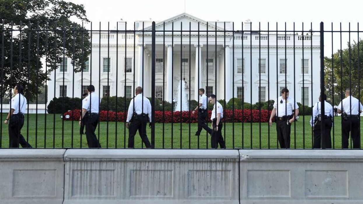 Guards patrol the White House lawn after a man jumped over the fence on Friday