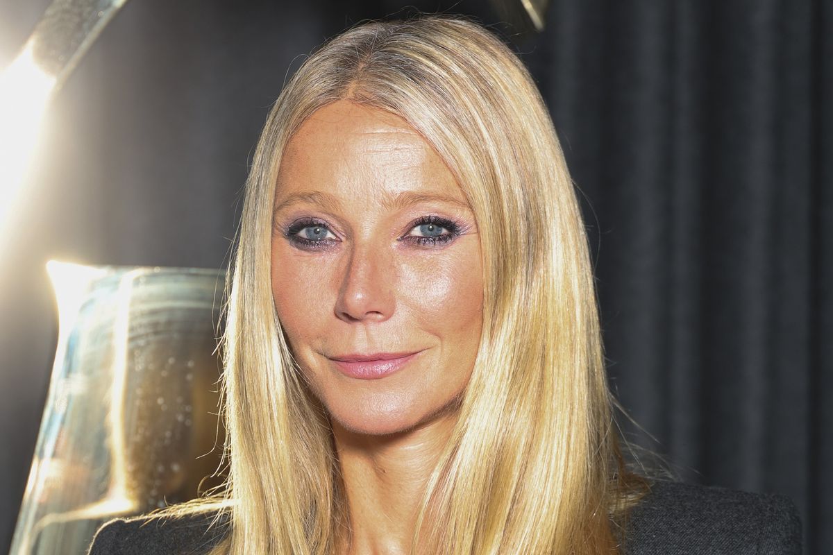 Gwyneth Paltrow wears purple eye makeup and a black suit at the Saint Laurent fashion show