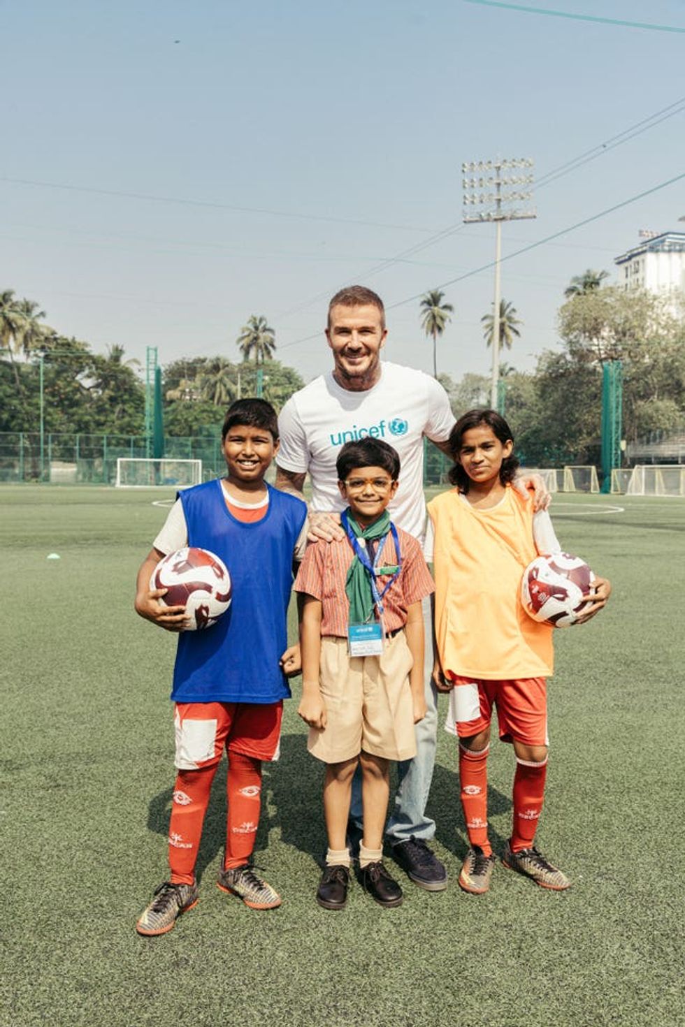 Handout photo issued by Unicef of their Goodwill Ambassador Sir David Beckham with Rohit, Tirth and Khushi, some of the children from underserved communities who have been trained in football and life skills by the Oscar Foundation, at the Cooperage Football Grounds in Mumbai during his second visit to India with Unicef