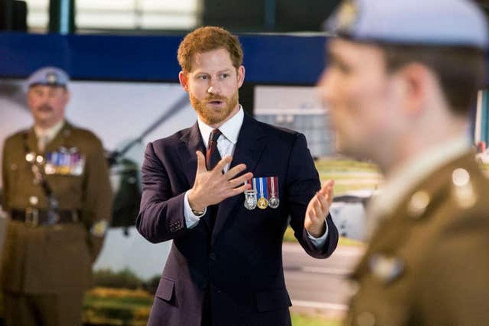 Harry in a suit and wearing medals on a visit to an Army Aviation Centre