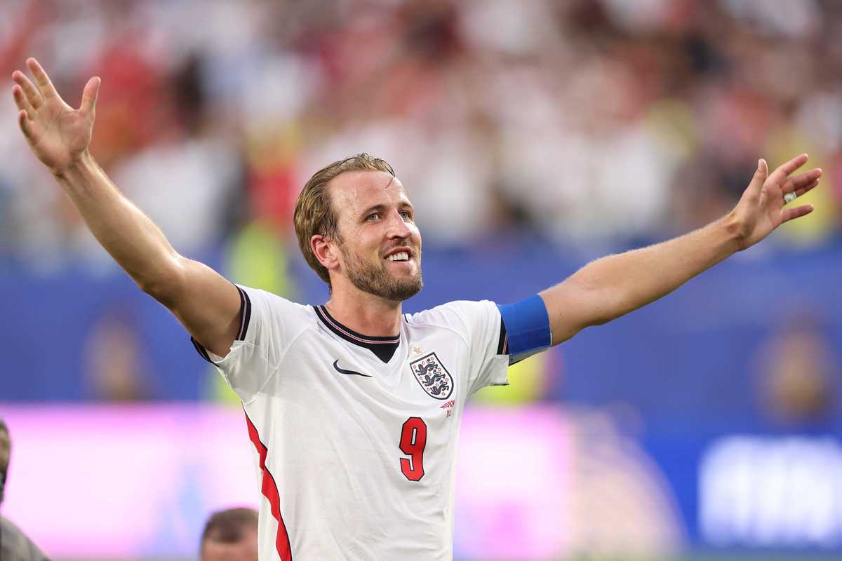 Harry Kane raises his hands in celebration during an England football match.