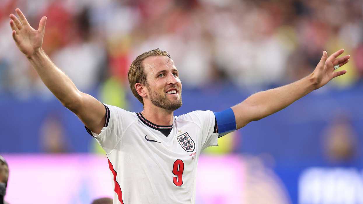 Harry Kane raises his hands in celebration during an England football match.