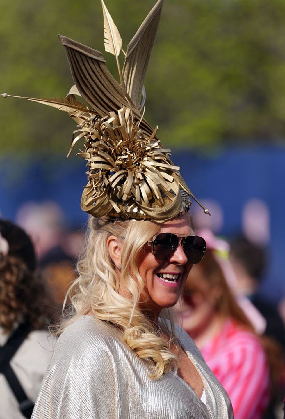 Heather Burnside wearing a large gold fascinator