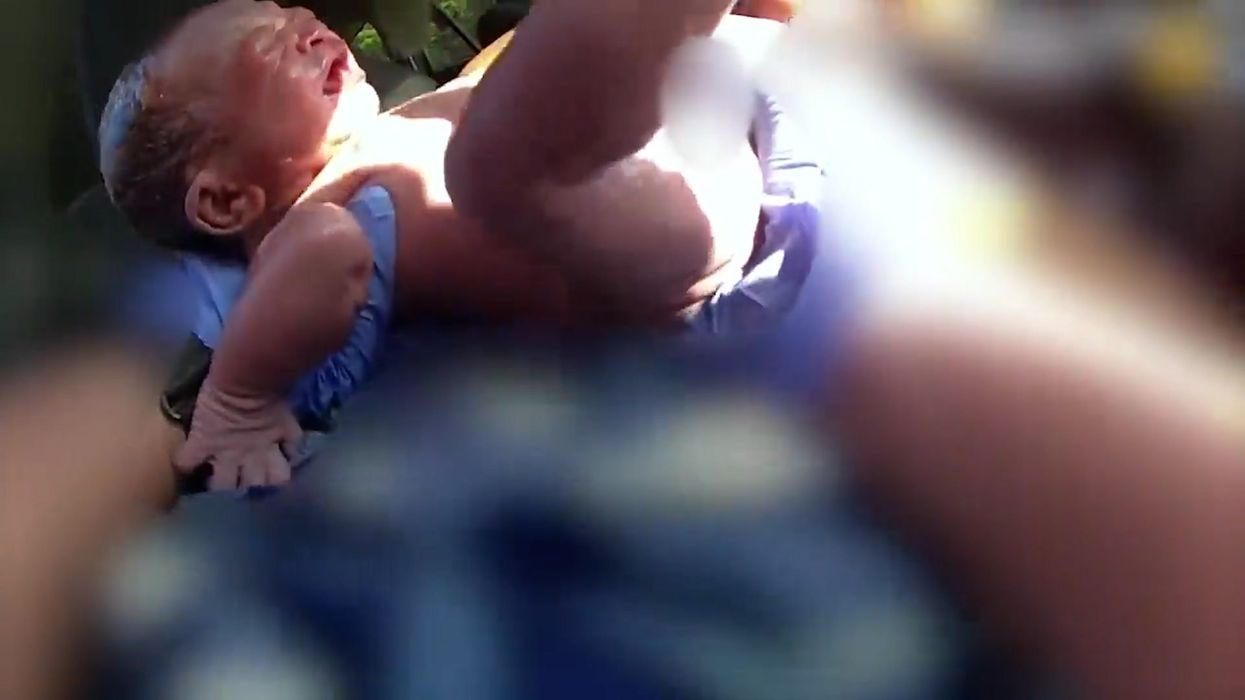 Moment quick-thinking police officer delivers baby in car on highway