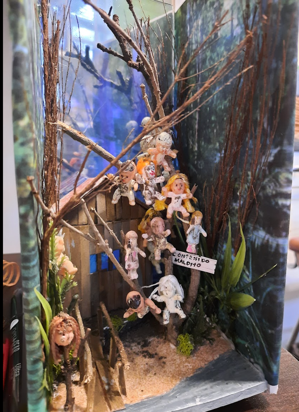 House and dolls surrounding it