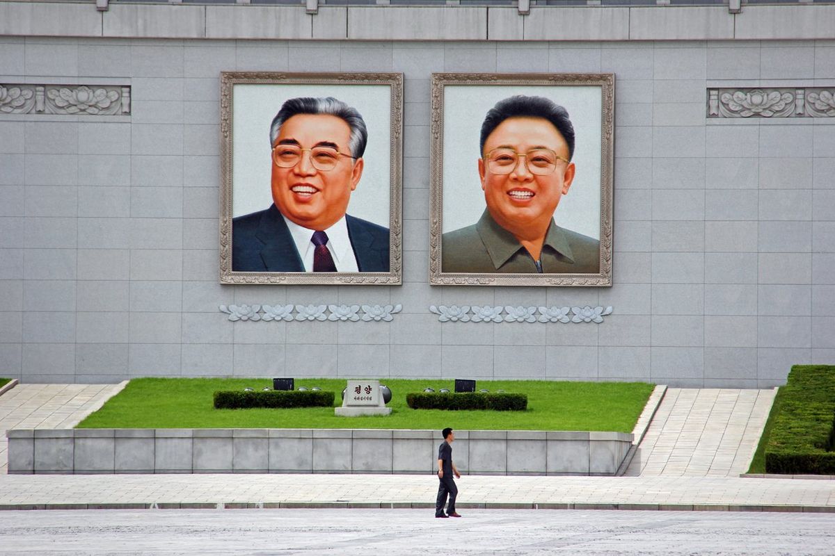 Huge portraits of Kim Il Sung and Kim Jong Il loom over Kim Il Sung Square in Pyongyang, North Korea