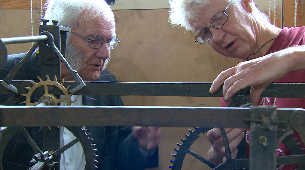Humphrey Hamlin (left), who previously worked on restoring the clock, joins Mr Boyd in re-installing the mechanism inside the church tower (Grace productions/PA)
