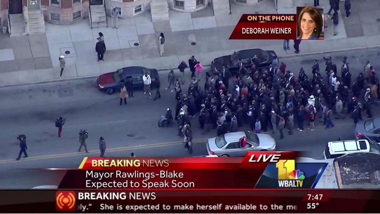 Hundreds of members of Baltimore clergy march through the streets calling for calm