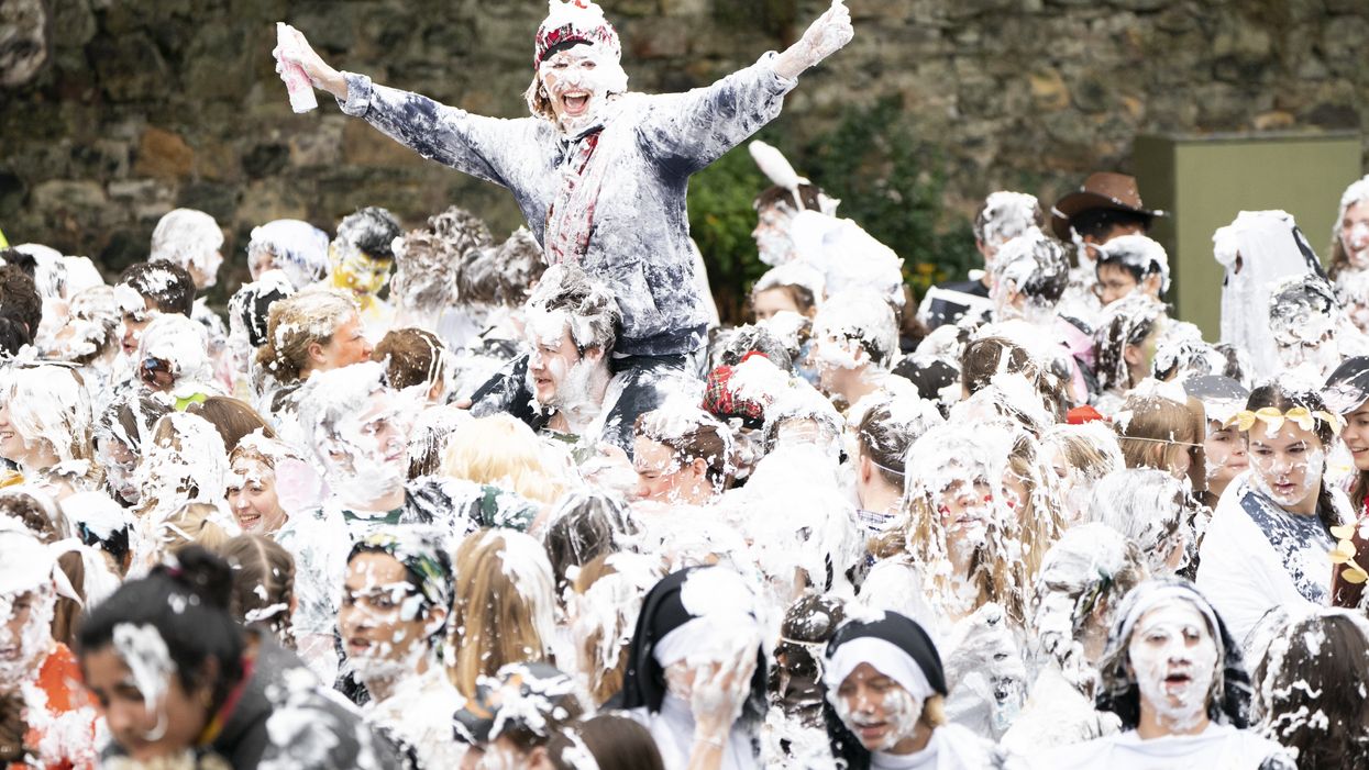 Hundreds of students take part in the traditional Raisin Monday foam fight on St Salvator’s Lower College Lawn at the University of St Andrews in Fife (Jane Barlow/PA)