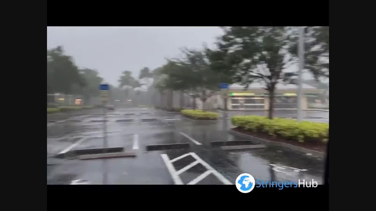 Moment a million-dollar McLaren sports car was washed away by Florida floodwater