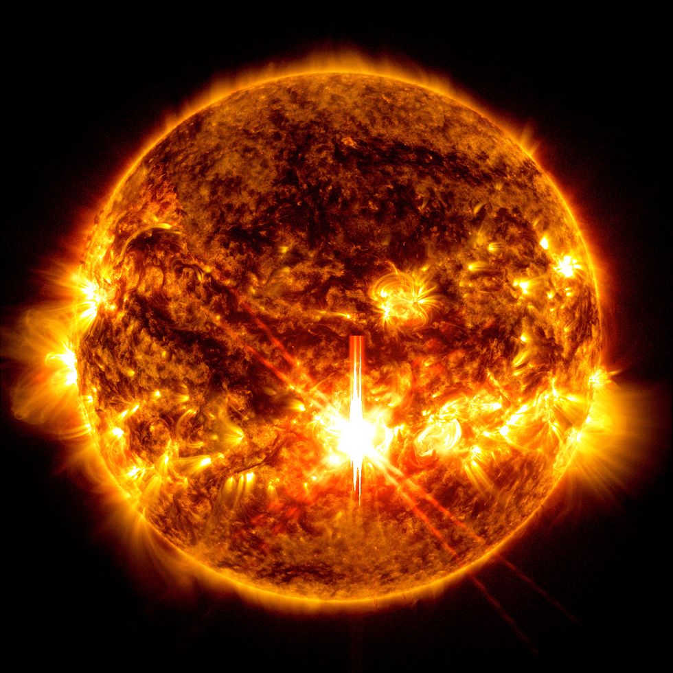 Image of an X9.0 solar flare \u2013 as seen in the bright orange flash in the centre of the sun