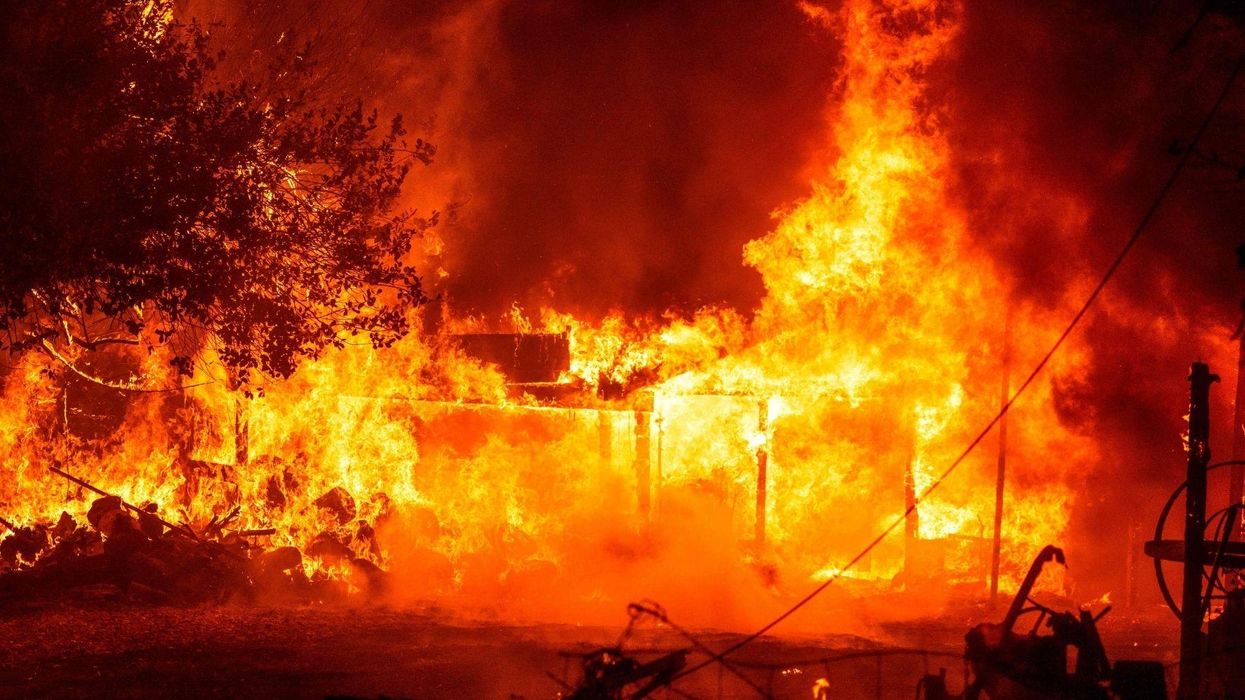 Influencer poses in front of sky turned orange by deadly wildfires to advertise a dress
