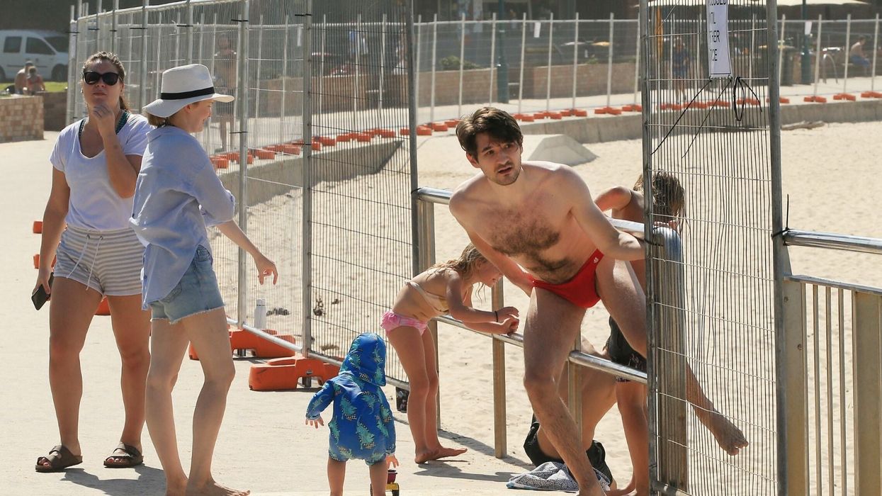 Australians seen climbing fences to defy the government's coronavirus beach ban