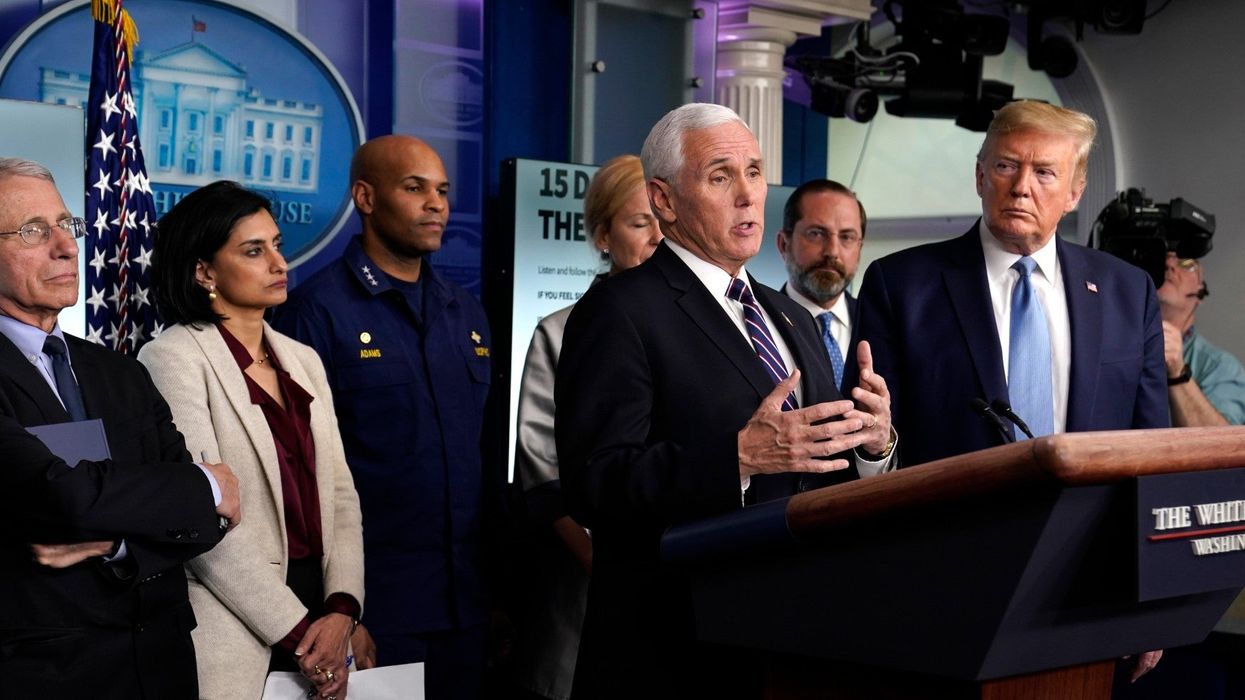 Trump tells Americans to avoid crowds of 10, while surrounded by 15 people