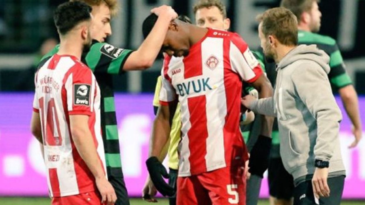 Football fans chant 'Nazis out' after racist abuse of player in Germany