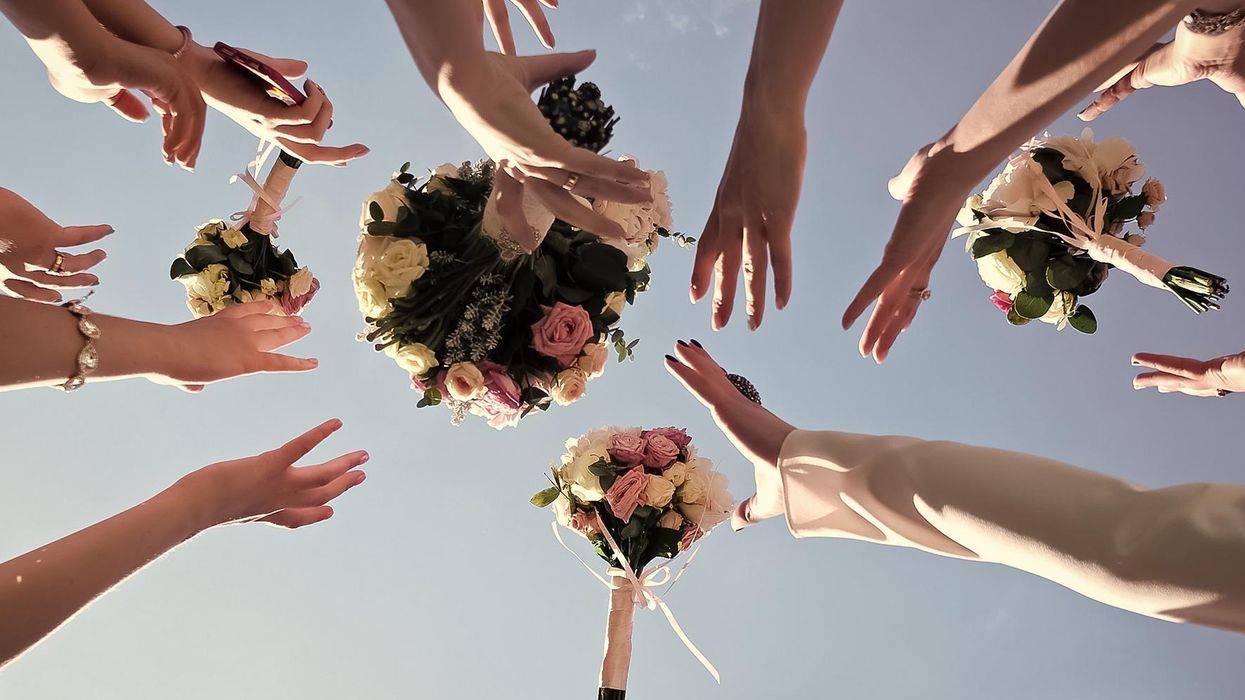 This man had the funniest reaction to his girlfriend catching the bouquet at a wedding